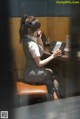 A woman sitting at a desk talking on a phone.